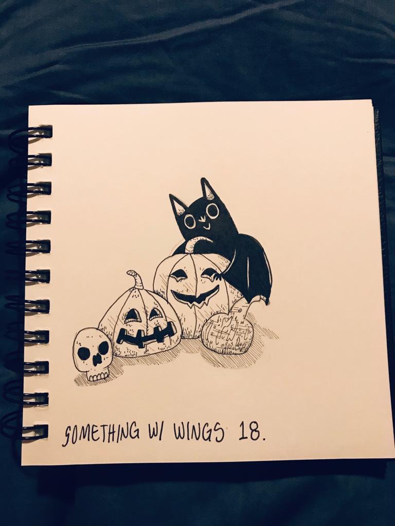 A picture of a bat with 3 jack-o-lanterns, which is nibbling on the largest jack-o-lantern